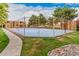 Outdoor basketball court with well-kept blue surface inside fence in a community complex surrounded by lush landscaping at 14402 N 58Th Dr, Glendale, AZ 85306
