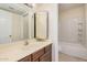 Bathroom featuring a sink, cabinets, mirror and a shower over tub at 14402 N 58Th Dr, Glendale, AZ 85306