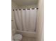 Standard bathroom with a combination bathtub and shower featuring a white shower curtain at 14402 N 58Th Dr, Glendale, AZ 85306