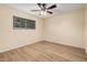 Spacious bedroom with ceiling fan, window and laminate floors at 14402 N 58Th Dr, Glendale, AZ 85306