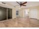 Large bedroom featuring hardwood floors and ceiling fan, with access to bathroom at 14402 N 58Th Dr, Glendale, AZ 85306