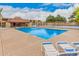 Community pool with chairs offering residents a relaxing outdoor oasis and is located close to the basketball court at 14402 N 58Th Dr, Glendale, AZ 85306
