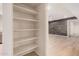 Hallway with shelving leading into a spacious room at 14402 N 58Th Dr, Glendale, AZ 85306
