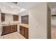 Kitchen with breakfast bar, tile floor, and oak cabinets at 14402 N 58Th Dr, Glendale, AZ 85306