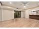 Bright living space flowing to the kitchen area featuring laminate floors and modern lighting at 14402 N 58Th Dr, Glendale, AZ 85306