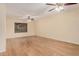 Expansive living room featuring laminate floors, neutral walls, ceiling fan, and a large window at 14402 N 58Th Dr, Glendale, AZ 85306
