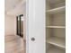 White pantry with shelves next to a sliding glass door at 14402 N 58Th Dr, Glendale, AZ 85306
