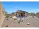 Backyard featuring a covered patio and desert landscaping at 14408 W Bloomfield Rd, Surprise, AZ 85379