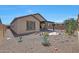 Backyard with desert landscaping and covered patio at 14408 W Bloomfield Rd, Surprise, AZ 85379
