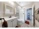 Clean bathroom featuring a stand-up shower, a single sink vanity, and linen storage at 14408 W Bloomfield Rd, Surprise, AZ 85379