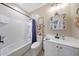 Cozy bathroom featuring a shower-tub combo and white vanity at 14408 W Bloomfield Rd, Surprise, AZ 85379