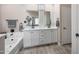 Stylish bathroom with double sinks, a soaking tub, and modern fixtures at 14408 W Bloomfield Rd, Surprise, AZ 85379
