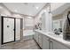 Modern bathroom with a glass-enclosed shower, soaking tub, and double vanity sinks at 14408 W Bloomfield Rd, Surprise, AZ 85379