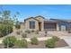 Charming single-story home featuring stucco exterior, desert landscaping, and a two-car garage at 14408 W Bloomfield Rd, Surprise, AZ 85379