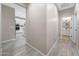 Bright hallway featuring tile floors and leading to the kitchen and bathroom at 14408 W Bloomfield Rd, Surprise, AZ 85379