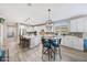 Spacious kitchen features white cabinets, stainless steel appliances, and a center island with bar seating at 14408 W Bloomfield Rd, Surprise, AZ 85379