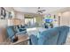 Cozy living room featuring a ceiling fan, patio access, and stylish decor at 14408 W Bloomfield Rd, Surprise, AZ 85379