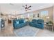 Spacious living room with wood floors, ceiling fan, and a view to the kitchen at 14408 W Bloomfield Rd, Surprise, AZ 85379