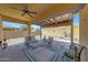 Inviting covered patio with a ceiling fan, perfect for relaxing outdoors at 14408 W Bloomfield Rd, Surprise, AZ 85379