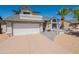 Charming home featuring a two-car garage, desert landscaping, and a mature palm tree at 14624 N 44Th St, Phoenix, AZ 85032
