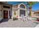 Inviting front porch with rocking chairs, decorative planters, and a paver walkway at 14624 N 44Th St, Phoenix, AZ 85032