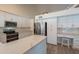 Spacious kitchen featuring white cabinets, quartz countertops, stainless steel appliances, and a functional desk space at 14624 N 44Th St, Phoenix, AZ 85032