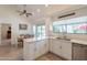 Bright and airy kitchen with stainless steel appliances, white cabinets, and a breakfast bar at 14624 N 44Th St, Phoenix, AZ 85032