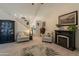 Inviting living room featuring a fireplace, comfortable seating, and a ceiling fan at 14624 N 44Th St, Phoenix, AZ 85032