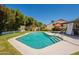 Backyard pool with desert landscaping, sunbathing area and shaded patio for ultimate relaxation at 14624 N 44Th St, Phoenix, AZ 85032