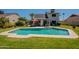 Backyard oasis featuring a well-maintained pool, expansive lawn, and outdoor seating for relaxation at 14624 N 44Th St, Phoenix, AZ 85032