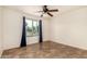 Bedroom featuring neutral finishes, ceiling fan, and large window for natural light at 1535 N Horne -- # 67, Mesa, AZ 85203
