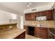Well-equipped kitchen with dark wood cabinets, stainless steel appliances, and a practical layout at 1535 N Horne -- # 67, Mesa, AZ 85203