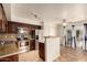 Modern kitchen with stainless steel appliances, dark cabinetry, and a convenient breakfast bar open to the living area at 1535 N Horne -- # 67, Mesa, AZ 85203