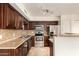 Functional kitchen featuring dark wood cabinets, stainless steel appliances, and ample countertop space at 1535 N Horne -- # 67, Mesa, AZ 85203