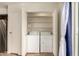 Laundry closet featuring washer and dryer with storage shelves and a door at 1535 N Horne -- # 67, Mesa, AZ 85203
