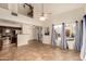 Bright and airy living room featuring tile flooring, large windows with blue curtains, and an open-concept layout at 1535 N Horne -- # 67, Mesa, AZ 85203