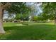 Community park view with benches and well-maintained green grass under mature trees at 1535 N Horne -- # 67, Mesa, AZ 85203