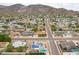 Picturesque aerial view of the neighborhood with mountain backdrop, solar panels and swimming pools at 1550 W Willow Ave, Phoenix, AZ 85029