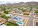 Stunning aerial view of a home with solar panels and a backyard pool in a quiet residential neighborhood at 1550 W Willow Ave, Phoenix, AZ 85029