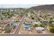 Overhead view of a residential neighborhood featuring houses with solar panels and well-maintained streets at 1550 W Willow Ave, Phoenix, AZ 85029