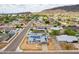 Gorgeous aerial view of the home with solar panels, desert landscaping, and a neighborhood view at 1550 W Willow Ave, Phoenix, AZ 85029