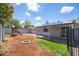 Backyard featuring a firepit, play structure, storage shed and solar panels at 1550 W Willow Ave, Phoenix, AZ 85029