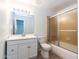 Bathroom features a shower with glass doors, a toilet, and a vanity with a white cabinet at 1550 W Willow Ave, Phoenix, AZ 85029
