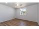 Bedroom features wood-look floors, white walls, a ceiling fan, and a window with a mountain view at 1550 W Willow Ave, Phoenix, AZ 85029