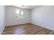 Bedroom features wood-look floors, white walls, and a window with a view of the outdoors at 1550 W Willow Ave, Phoenix, AZ 85029