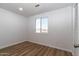 Bedroom features wood-look floors, white walls, and a window with a view of the outdoors at 1550 W Willow Ave, Phoenix, AZ 85029