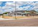 Charming home exterior with solar panels, carport, desert landscaping, and street view at 1550 W Willow Ave, Phoenix, AZ 85029