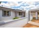 Charming home exterior with desert landscaping, carport, gray accents and security door at 1550 W Willow Ave, Phoenix, AZ 85029