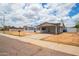 Inviting home exterior with a covered carport, desert landscaping, and street view at 1550 W Willow Ave, Phoenix, AZ 85029