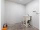 Clean laundry room featuring a utility sink with white brick walls at 1550 W Willow Ave, Phoenix, AZ 85029